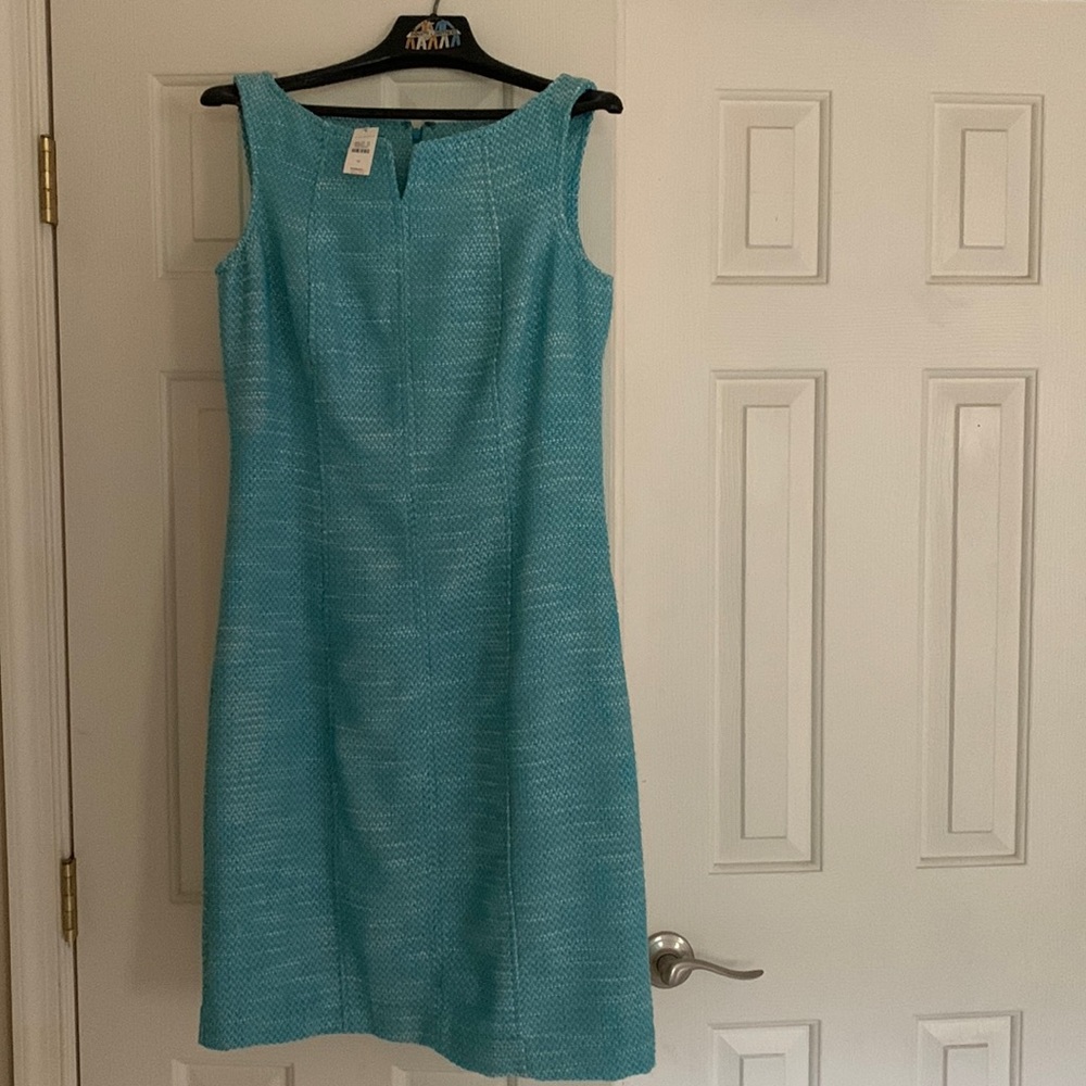 Aqua dress, never worn. Lined. Fabric is textured with aqua and white, lined.